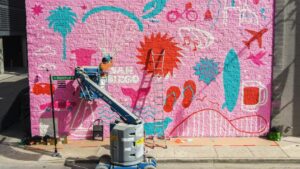 Pheobe Cornog painting a a mural in Chicago