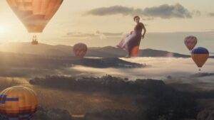 A woman floating among hot air balloons