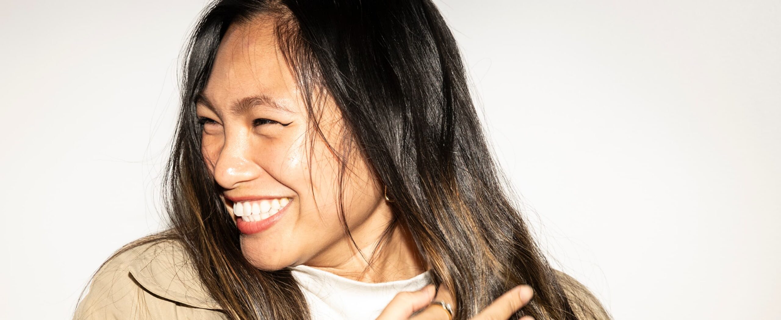 A woman smiling, looking off to the side