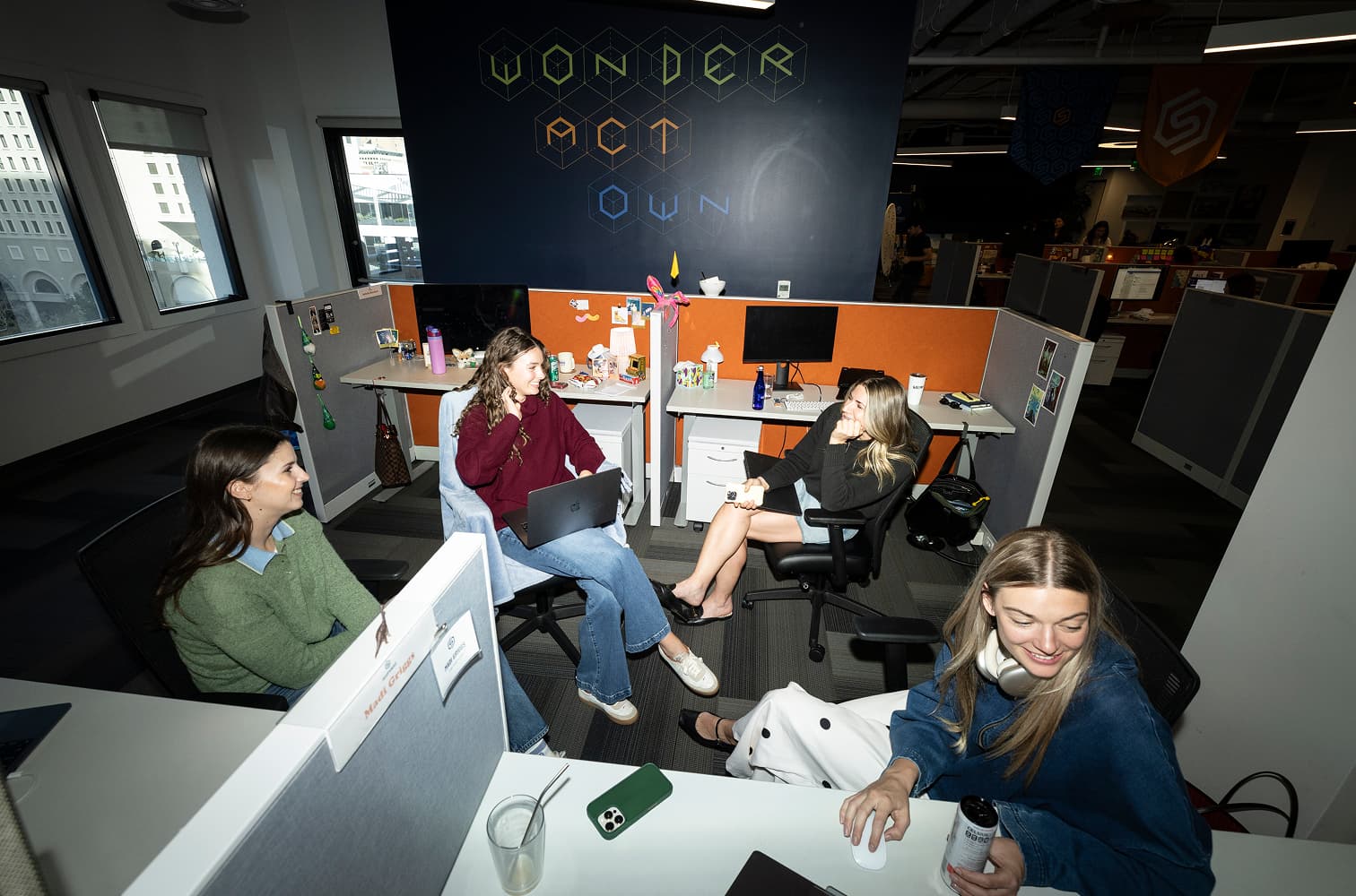 A group of four women working together in cubicles at The Shipyard