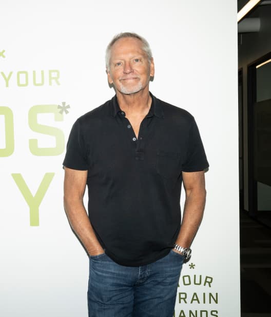 A man standing against a wall and confidently facing camera