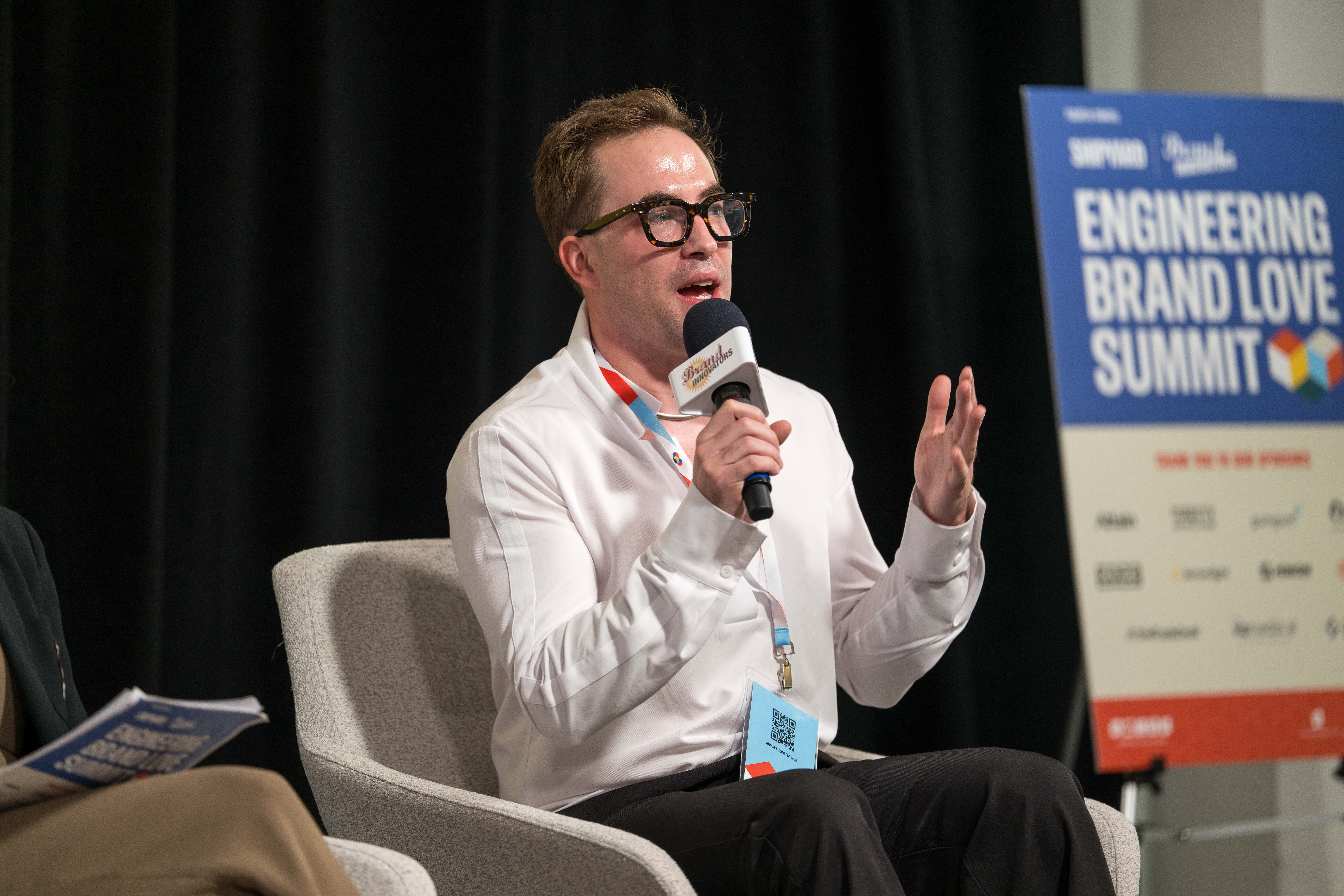 Evan Pardue sitting and speaking on stage at The Shipyard's 2026 Engineering Brand Love Summit